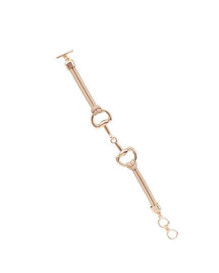 A rose gold equestrian-style chain accessory with a toggle clasp, ring, and snap hook details, shown on a solid white background.