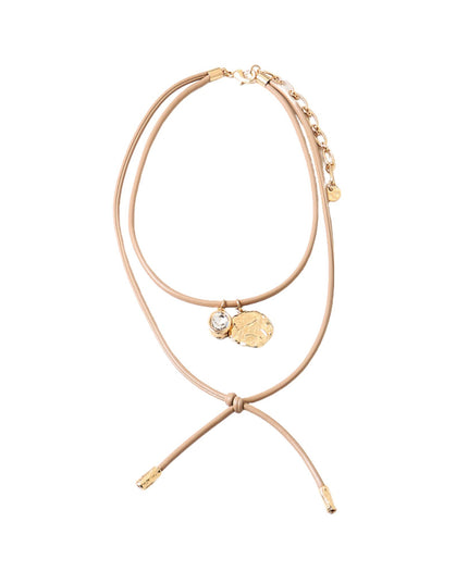 A delicate double-strand necklace featuring a tan or light beige cord with gold-toned charms, including a textured gold coin pendant, a small clear crystal charm, and a small gold bead accent, displayed on a clean white background.