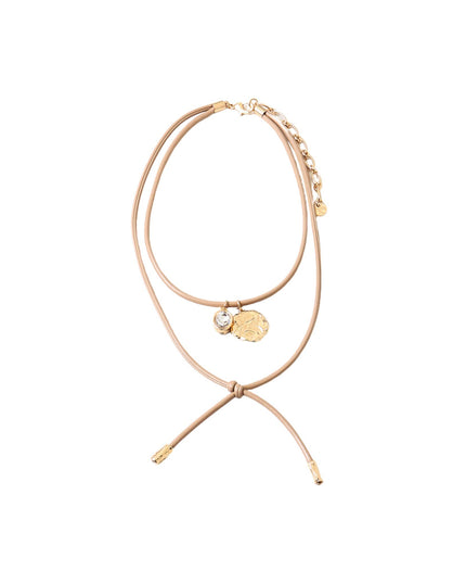 A delicate double-strand tan cord necklace with gold-toned charms, including a small round gold medallion and a clear rhinestone accent, displayed on a solid white background.