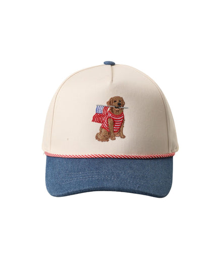 Cap with dog holding American flag design on beige and blue background