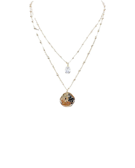 A double-strand necklace featuring a delicate gold chain with a small clear teardrop crystal pendant and a larger textured gold pendant with brown and black marbled details, shown on a plain white background.