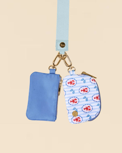 Blue pouch with a matching keychain on a beige background