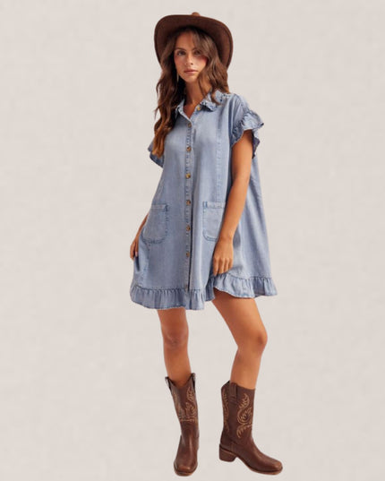 Woman wearing a denim dress and brown cowboy boots on a plain background