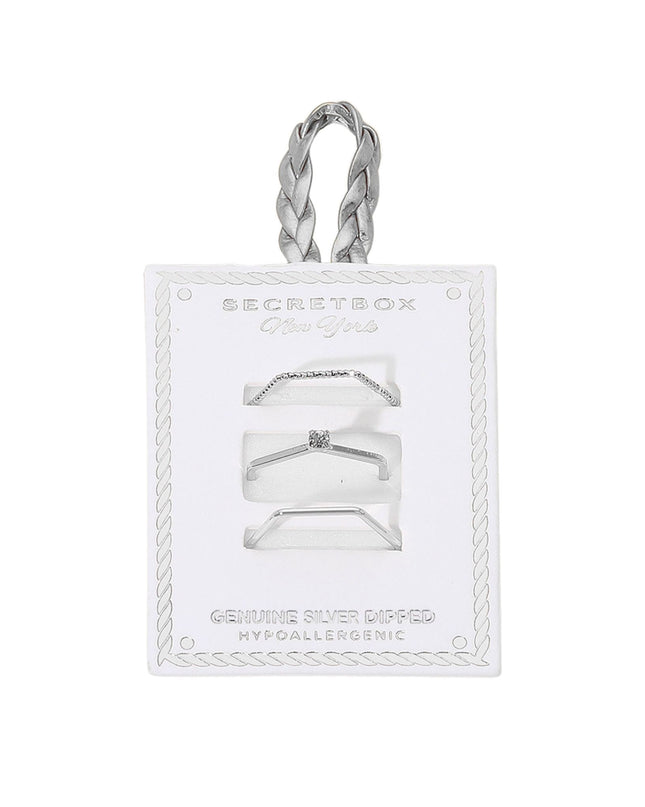 Silver ring set on a clear card with 'Secret Box' branding on a white background