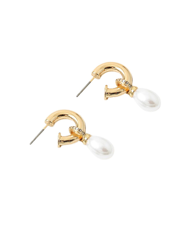 Gold and pearl earrings on a white background