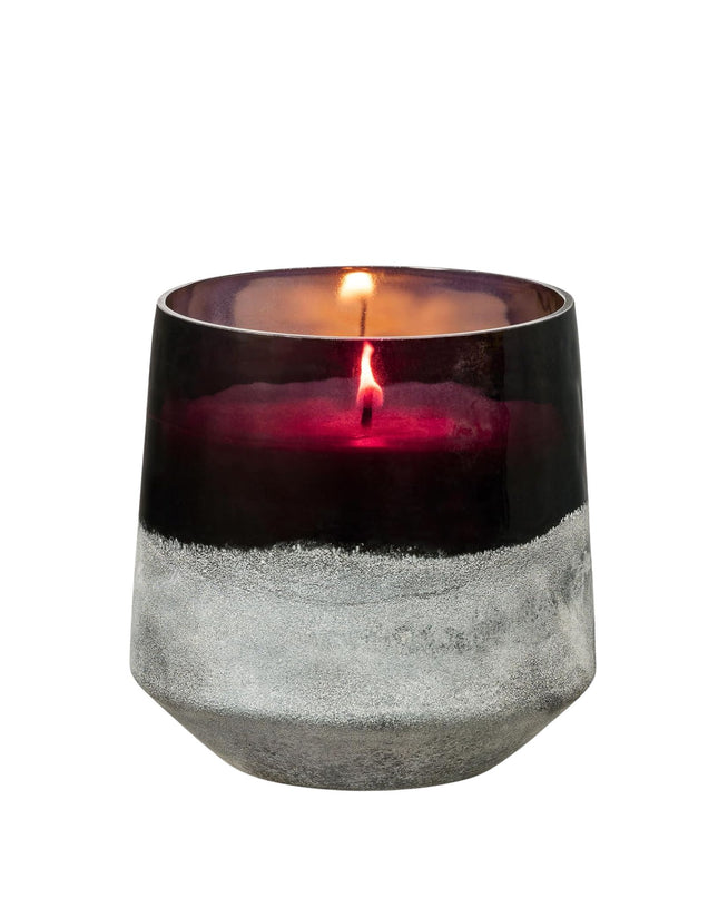 Candle in a decorative glass holder with a white background
