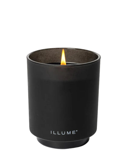 Black candle in a container with 'ILLUME' branding on a white background