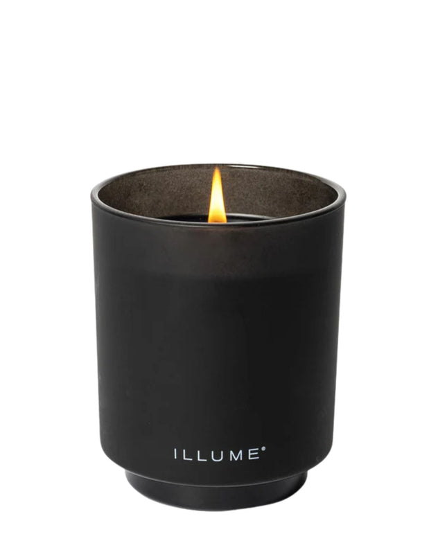 Black candle in a container with 'ILLUME' branding on a white background