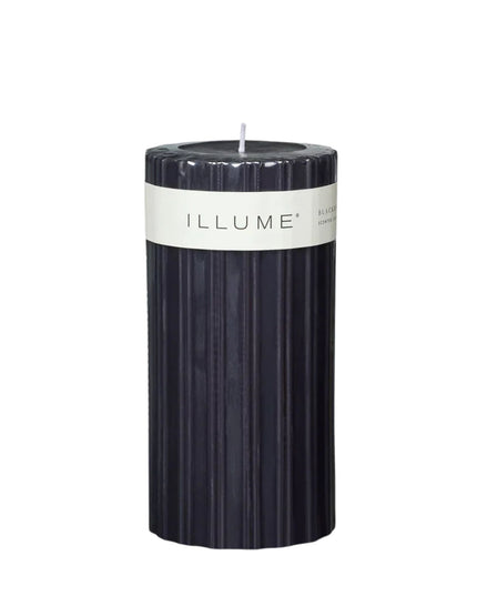 Black candle with 'ILLUME' label on a white background
