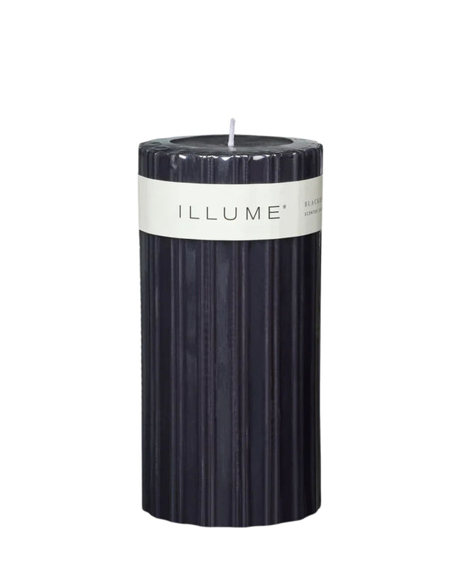 Black candle with 'ILLUME' label on a white background