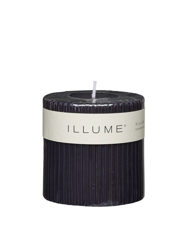 Black candle with 'ILLUME' label on a white background