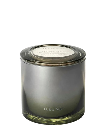 Smoky green candle with 'ILLUME' branding on a white background