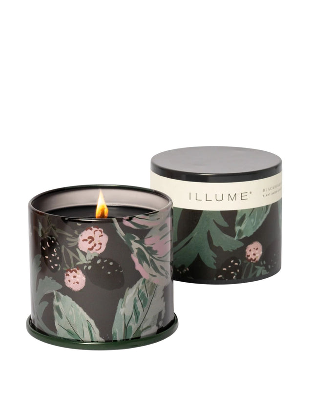 Floral-patterned candle in a tin with 'ILLUME' branding on a white background