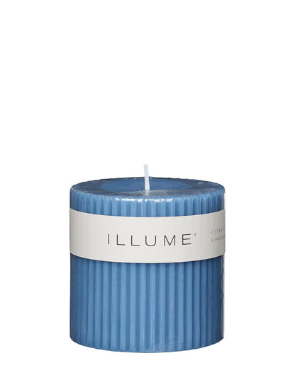 Blue candle with a white label on a white background
