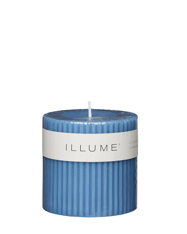 Blue candle with a white label on a white background