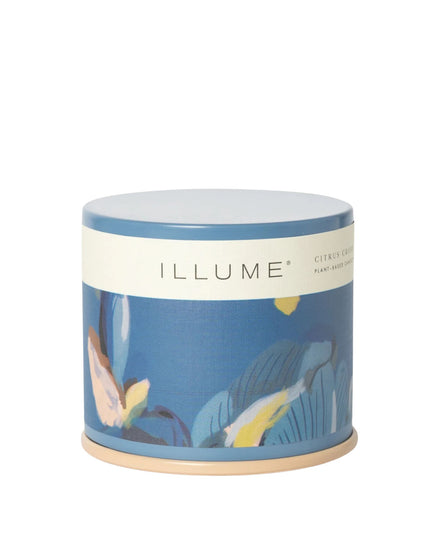 Candle in a decorative container with 'ILLUME' branding on a white background