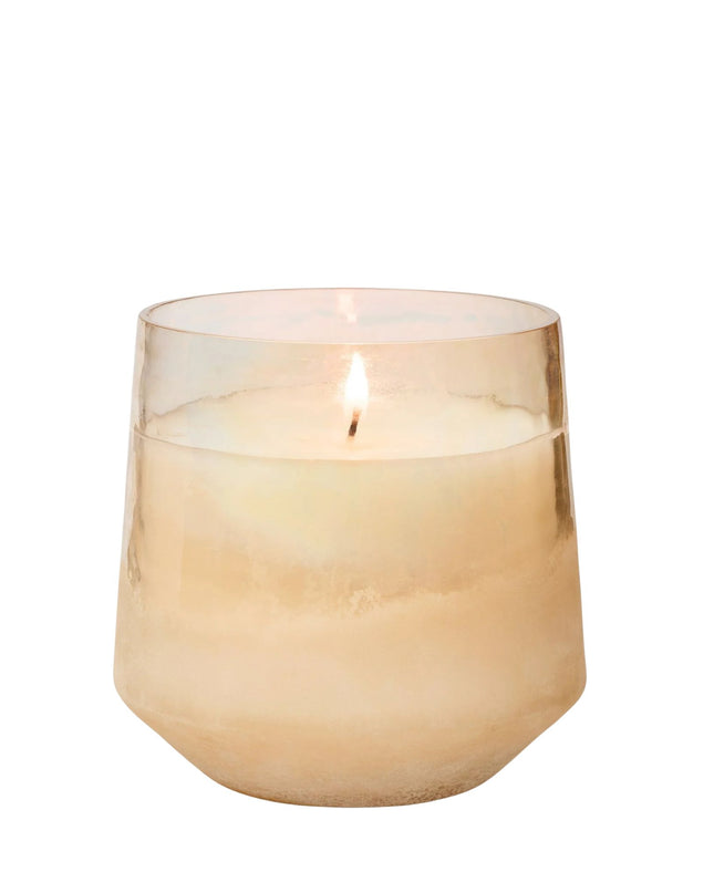 Candle in a glass holder on a white background