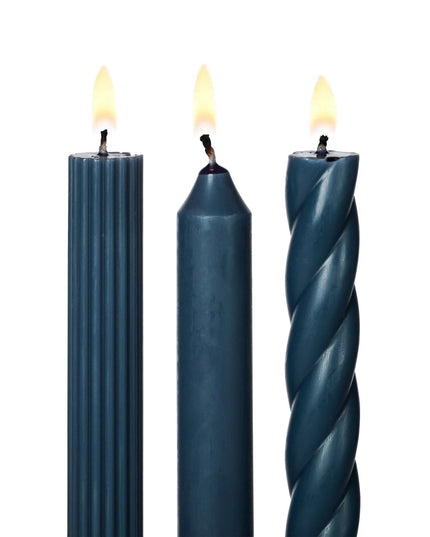 Three blue candles with different textures on a white background