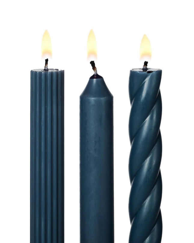 Three blue candles with different textures on a white background