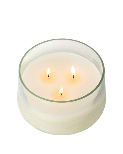 Glass candle with three wicks on a white background