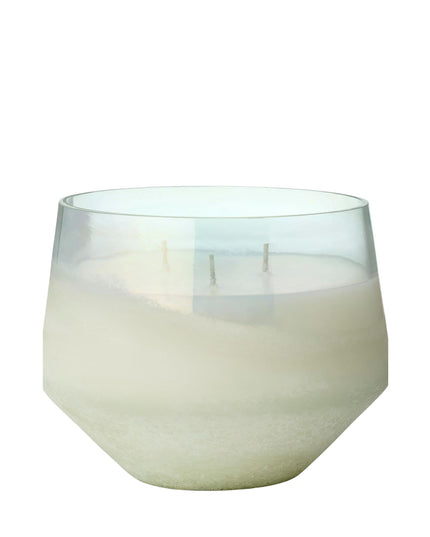 White candle in a glass container on a white background