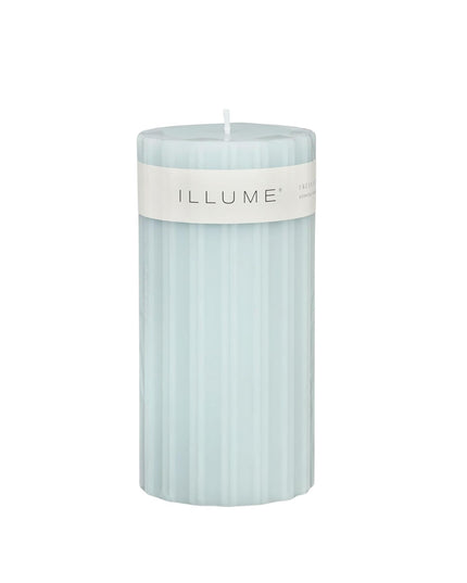 Light blue candle with 'ILLUME' label on a white background