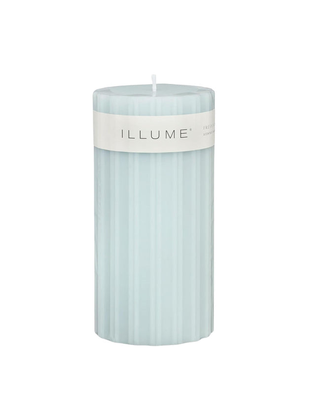 Light blue candle with 'ILLUME' label on a white background
