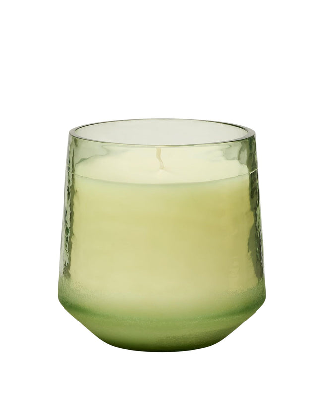 Green glass tumbler on a white background
