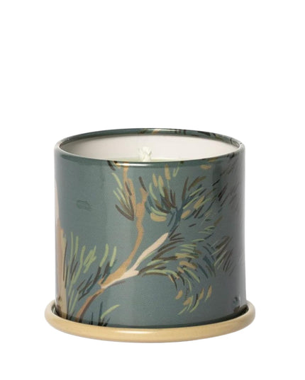 Candle in a decorative tin with floral design on a white background