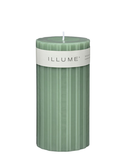 Green candle with 'ILLUME' label on a white background
