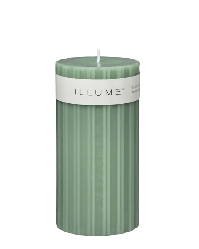 Green candle with 'ILLUME' label on a white background