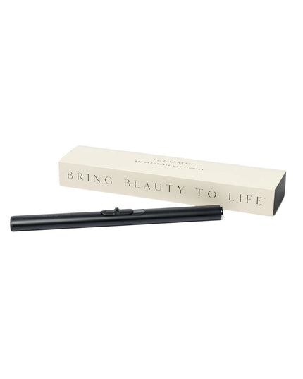 Black eyelash curler with beige box on a white background