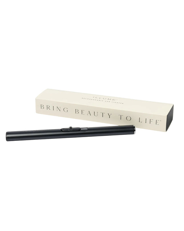 Black eyelash curler with beige box on a white background