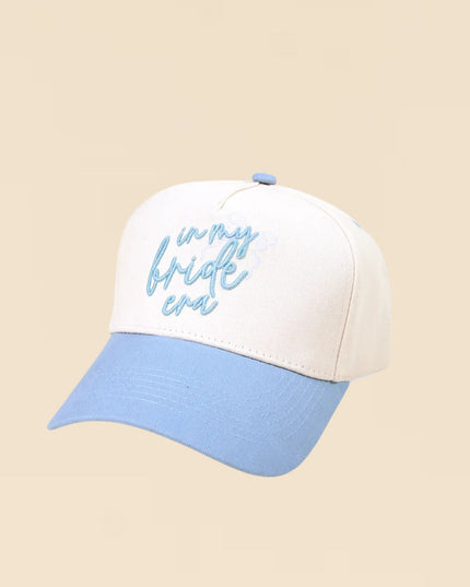 Cap with 'in my bride era' text on a beige background