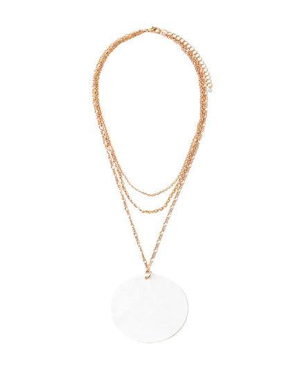 A rose gold layered necklace featuring three delicate chain layers and a large, flat circular disc pendant, displayed against a solid white background.