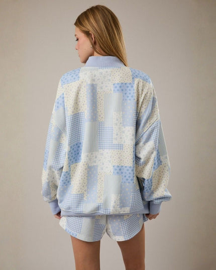 Person wearing a light blue and white checkered outfit on a beige background