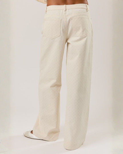 Beige wide-leg pants on a plain background