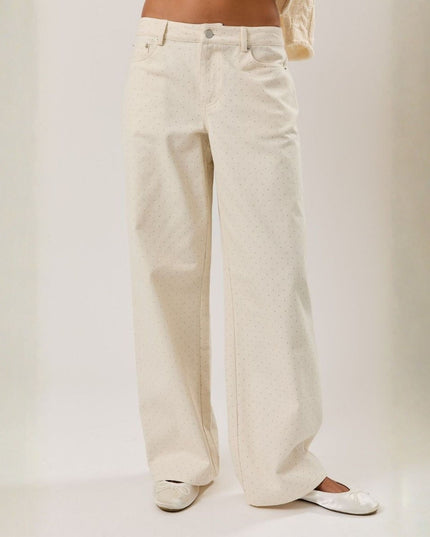 White wide-leg pants worn by a person on a plain background