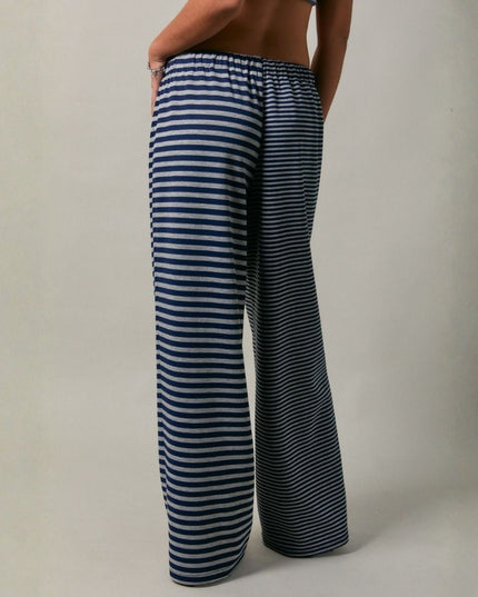 Person wearing blue and white striped pants on a plain background
