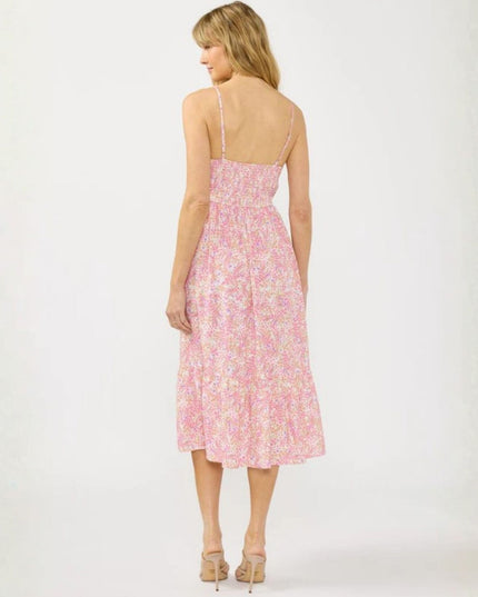 Woman wearing a pink floral dress on a white background