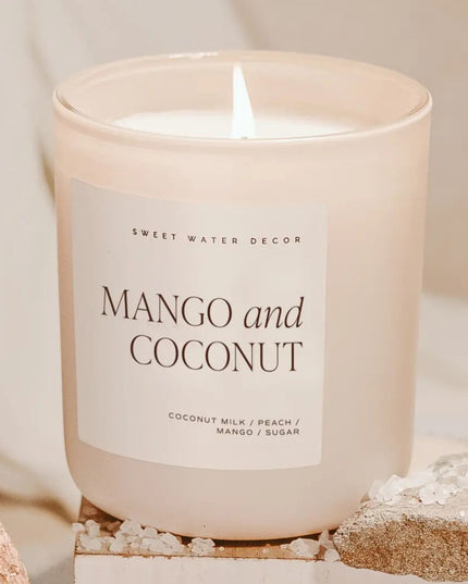 Candle with 'Mango and Coconut' label on a neutral background