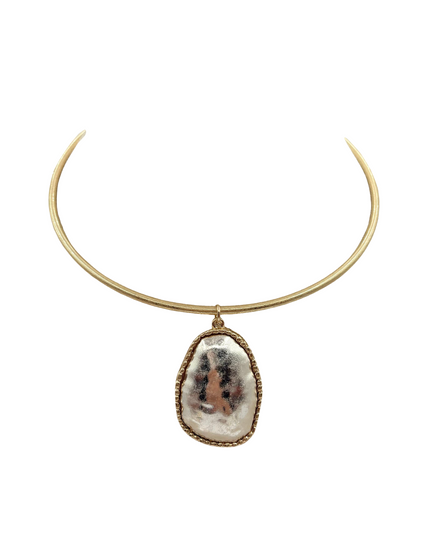 A gold-toned metal collar necklace with a teardrop-shaped pendant featuring a textured, organic white and gray stone in a gold bezel setting, shown against a plain white background.