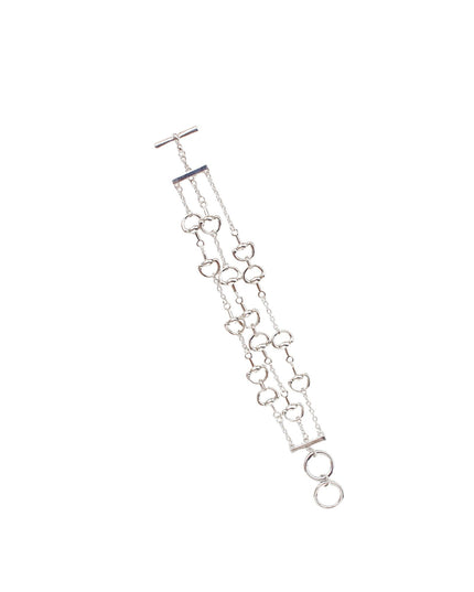 A silver-toned multi-strand chain bracelet with open heart links, a T-bar clasp, and a dangling ring, shown on a plain white background.