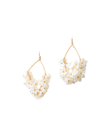 A pair of gold-tone dangle earrings featuring clusters of small white flowers, shown against a plain white background.