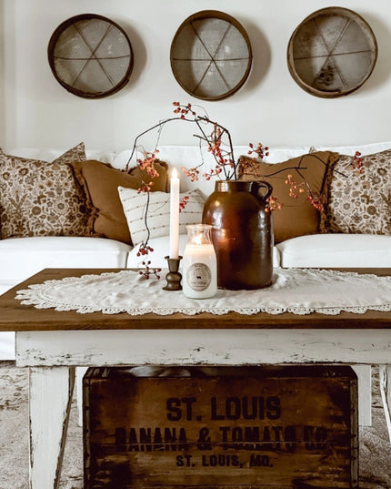 Living room with a white sofa, wooden coffee table, and decorative items.