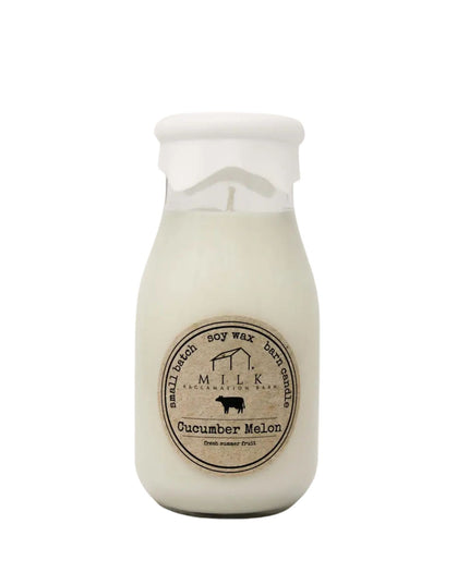 Candle in a milk bottle with a label on a white background