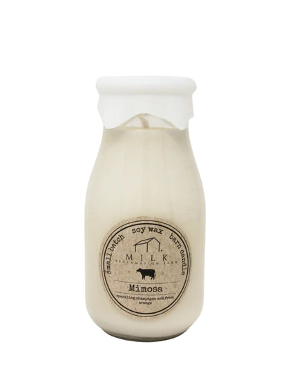 Milk bottle-shaped candle with label on a white background