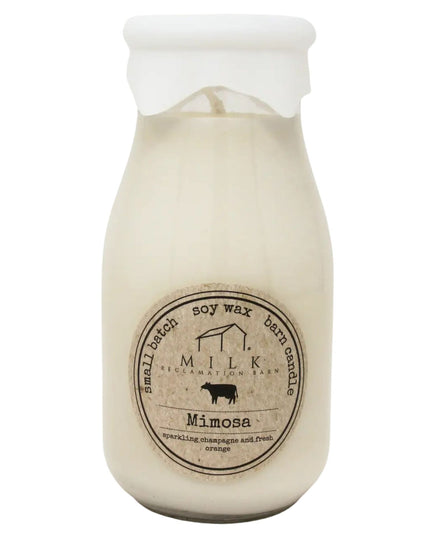 Soy wax candle in a milk bottle-shaped jar with 'Milk' branding on a white background