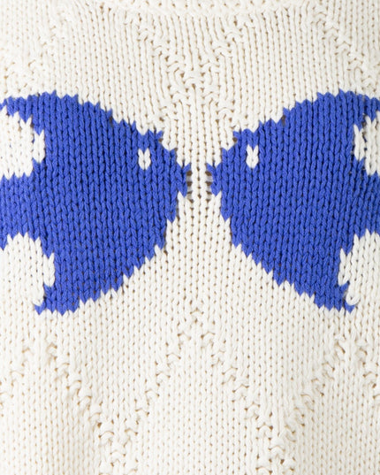 Close-up of a white fabric with blue fish patterns.