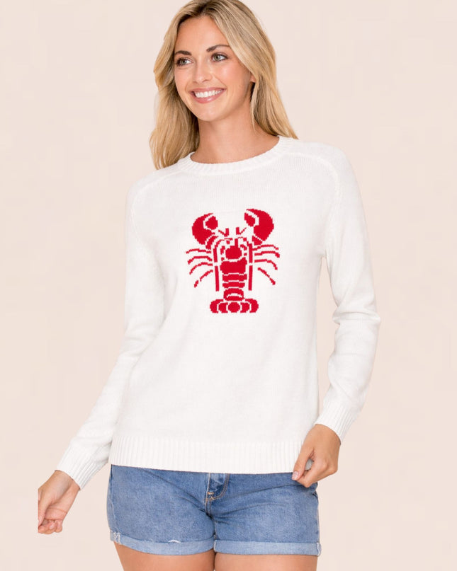 Woman wearing a white long-sleeve shirt with a red lobster design on a beige background